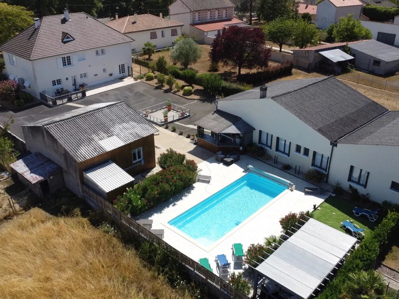 Aerial view over the whole property showing the pool, courtyard and four buildings