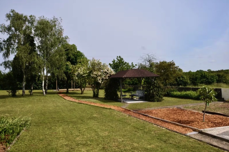Garden lawn, mature planting and gazebo