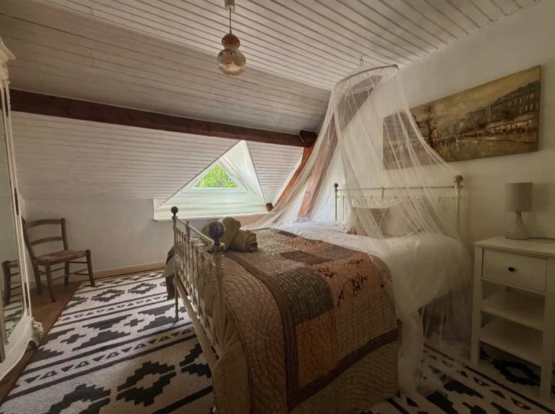 The third bedroom beneath the beams in the Main House attic